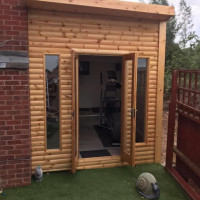 Wooden garden room being used as an at home gym